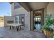 Covered patio with outdoor fireplace and dining area, seamlessly blending indoor and outdoor living at 12311 Middle Creek St, Las Vegas, NV 89138