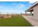 Inviting backyard with a covered patio, artificial turf, and a brick-paved walkway at 12550 Point Sierra St, Las Vegas, NV 89138
