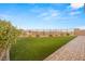 Well-maintained backyard features artificial grass, a brick paver walkway, and mountain views at 12550 Point Sierra St, Las Vegas, NV 89138