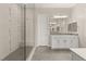 Bright bathroom with glass shower, white cabinets, and gray tile floors at 12550 Point Sierra St, Las Vegas, NV 89138
