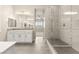 Bright primary bath featuring tiled floors, dual vanity, and glass shower at 12550 Point Sierra St, Las Vegas, NV 89138