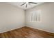 Well-lit bedroom with wood floors, a modern ceiling fan, and a large window with white shutters at 12550 Point Sierra St, Las Vegas, NV 89138