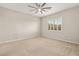 Comfortable carpeted bedroom with neutral colors, modern ceiling fan, and window shutters at 12550 Point Sierra St, Las Vegas, NV 89138