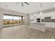 Modern kitchen with a center island, quartz countertops, and stainless steel appliances overlooking the backyard at 12550 Point Sierra St, Las Vegas, NV 89138
