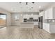 Open-concept kitchen with a center island, stainless steel appliances, and a sliding glass door to the back patio at 12550 Point Sierra St, Las Vegas, NV 89138