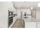 Bright kitchen featuring white cabinets, modern appliances, and a large center island for meal preparation at 12550 Point Sierra St, Las Vegas, NV 89138