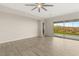 Open living room with a ceiling fan, wood floors, and sliding glass doors leading to the backyard and mountain views at 12550 Point Sierra St, Las Vegas, NV 89138