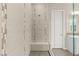 Modern shower with decorative tiling and built-in bench, featuring glass door and updated shower head at 12550 Point Sierra St, Las Vegas, NV 89138