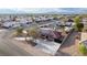 Aerial view of home with solar panels, a pool, desert landscaping, and a gated entrance at 1500 Tumbleweed Dr, Henderson, NV 89002