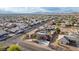 Picturesque aerial shot of a desert property showcasing a swimming pool, patio, and solar panels amidst suburban homes at 1500 Tumbleweed Dr, Henderson, NV 89002