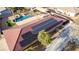 This aerial view shows the home's roof with solar panels, leading to a beautiful pool and landscape backyard at 1500 Tumbleweed Dr, Henderson, NV 89002