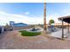 Large backyard with a pool, spa, rock waterfall, and covered parking for a recreational vehicle at 1500 Tumbleweed Dr, Henderson, NV 89002