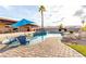 Backyard features a pool with a spa, palm tree, pavers and artificial grass at 1500 Tumbleweed Dr, Henderson, NV 89002