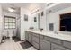 Well lit bathroom offering double sinks with expansive counter space and a shower-tub combo at 1500 Tumbleweed Dr, Henderson, NV 89002