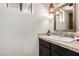 Stylish half bathroom featuring black vanity with designer hardware and light at 1500 Tumbleweed Dr, Henderson, NV 89002