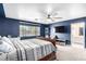 Comfortable primary bedroom featuring a ceiling fan, plush carpeting, and a view of the outside at 1500 Tumbleweed Dr, Henderson, NV 89002