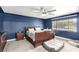 Cozy bedroom featuring a ceiling fan, plush carpeting, and a view of the outside at 1500 Tumbleweed Dr, Henderson, NV 89002