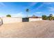 Property featuring a block wall, metal gate, and desert landscaping under a clear blue sky at 1500 Tumbleweed Dr, Henderson, NV 89002