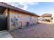 Exterior of the house showing the side yard with gravel and a covered parking space for recreational vehicles at 1500 Tumbleweed Dr, Henderson, NV 89002