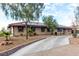 Beautiful single-story home with solar panels, desert landscaping, and a long driveway at 1500 Tumbleweed Dr, Henderson, NV 89002