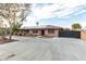 Charming single-story home with a gated extended driveway and desert landscaping at 1500 Tumbleweed Dr, Henderson, NV 89002