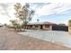 Inviting single-story home featuring desert landscaping and an extended driveway with gate at 1500 Tumbleweed Dr, Henderson, NV 89002