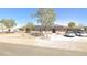 Charming front view of a desert home featuring a driveway and solar panels, blending comfort with energy efficiency at 1500 Tumbleweed Dr, Henderson, NV 89002