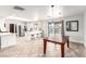 Eat-in kitchen with white cabinets, stainless appliances, quartz counters, and dining table with a view of backyard and pool at 1500 Tumbleweed Dr, Henderson, NV 89002