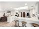Spacious kitchen with skylight features white cabinets, stainless appliances and a quartz countertop island with bar stool seating at 1500 Tumbleweed Dr, Henderson, NV 89002