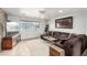 Comfortable living room featuring tile floors, a large window, and a cozy sectional sofa at 1500 Tumbleweed Dr, Henderson, NV 89002