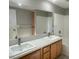 Bathroom features a double sink vanity with granite countertop and tiled shower at 2105 William Holden Ct, Las Vegas, NV 89142