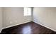 A cozy bedroom featuring modern wood flooring and a bright window at 2105 William Holden Ct, Las Vegas, NV 89142