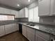 Galley style kitchen featuring granite countertops, tile floors, and white cabinetry at 2105 William Holden Ct, Las Vegas, NV 89142