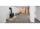 Finished basement with carpet, wood accent wall, a barn door, and a cozy wood-burning stove at 2160 Via Vita St, Mount Charleston, NV 89124