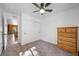 Bright bedroom with carpet, ceiling fan, large closet, dresser and doorway to an adjacent room at 2160 Via Vita St, Mount Charleston, NV 89124