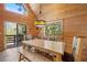 Dining area with wooden table and chairs, natural light, and sliding door to balcony at 2160 Via Vita St, Mount Charleston, NV 89124