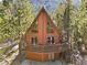 Inviting a-frame cabin featuring a large deck, wood siding, and stunning mountain views at 2160 Via Vita St, Mount Charleston, NV 89124