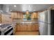 Bright kitchen with stainless steel appliances, wooden cabinets, and a farmhouse sink at 2160 Via Vita St, Mount Charleston, NV 89124