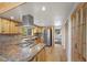 Spacious kitchen features stainless appliances, stone countertops, wood cabinets, and hardwood floors at 2160 Via Vita St, Mount Charleston, NV 89124