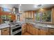 Modern kitchen features wooden cabinets, stainless appliances, stone countertops, and scenic views at 2160 Via Vita St, Mount Charleston, NV 89124