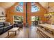 Spacious cabin living room with wood-paneled walls, a cozy fireplace, and views of the surrounding nature at 2160 Via Vita St, Mount Charleston, NV 89124