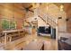 Open floor plan with wood paneling and staircase leading to the loft at 2160 Via Vita St, Mount Charleston, NV 89124