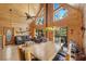 Open-concept living room featuring wood-paneled walls, a fireplace, and a dining area perfect for mountain living at 2160 Via Vita St, Mount Charleston, NV 89124