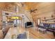 Open floor plan features a living room, kitchen, and dining area with wood paneled walls at 2160 Via Vita St, Mount Charleston, NV 89124