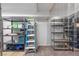 Organized storage room with shelving units and a ladder for accessing higher storage areas at 2160 Via Vita St, Mount Charleston, NV 89124