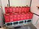 Battery bank powers a sustainable lifestyle: multiple red batteries neatly arranged in a dedicated utility room at 2160 Via Vita St, Mount Charleston, NV 89124