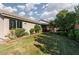 Large backyard with a covered patio, lush lawn, and privacy landscaping at 240 Jumping Springs Pl, Henderson, NV 89012