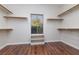 Walk-in closet with laminate floor and shelving, providing efficient and organized storage space at 240 Jumping Springs Pl, Henderson, NV 89012