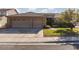 Inviting home showcasing a three-car garage, manicured lawn, and lush landscaping at 240 Jumping Springs Pl, Henderson, NV 89012
