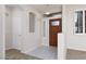 Bright entryway features tile flooring, a decorative light fixture and a stylish front door at 240 Jumping Springs Pl, Henderson, NV 89012